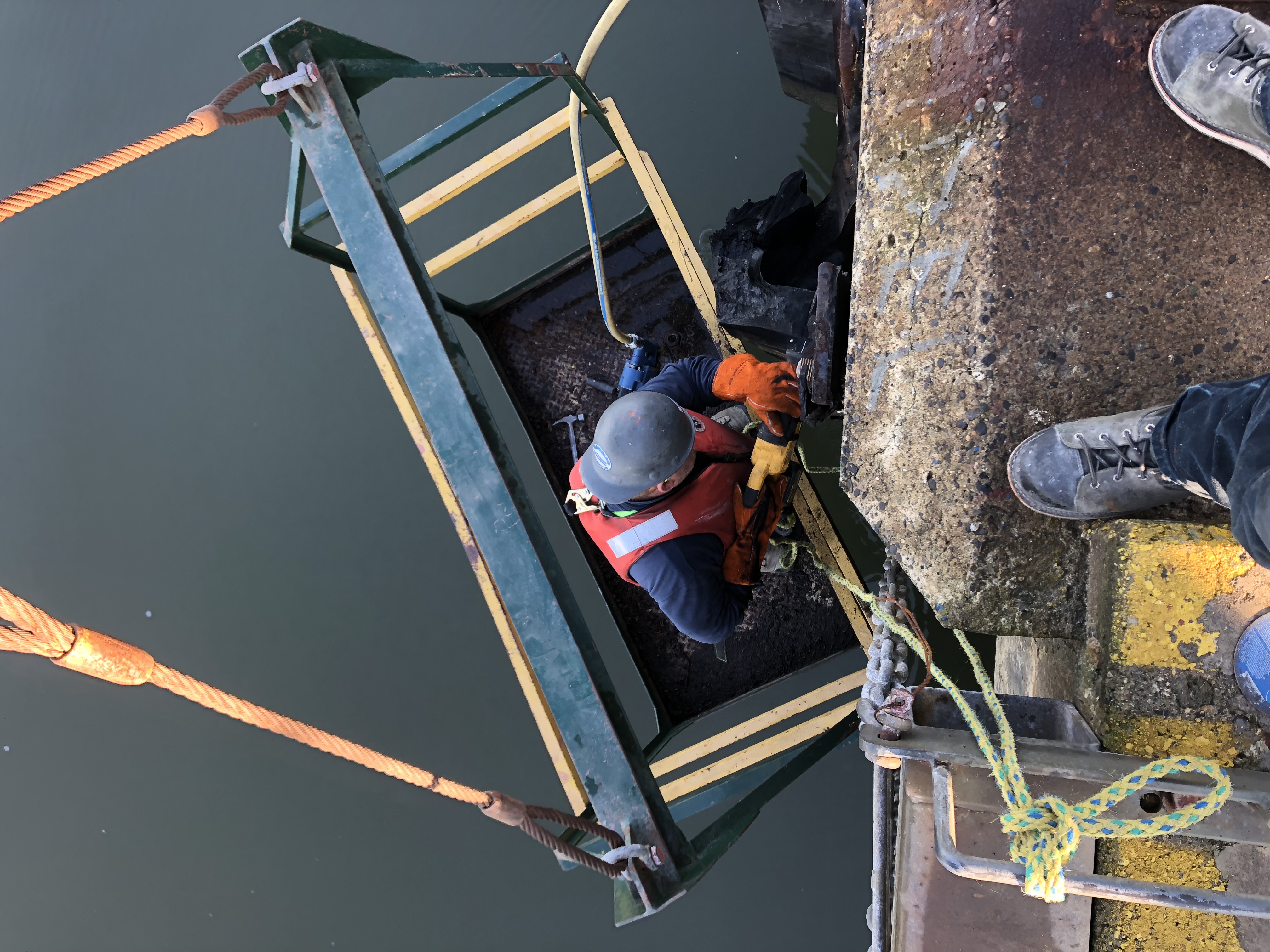 Technician on suspended access platform performing berth-side work at DP World Fraser Surrey